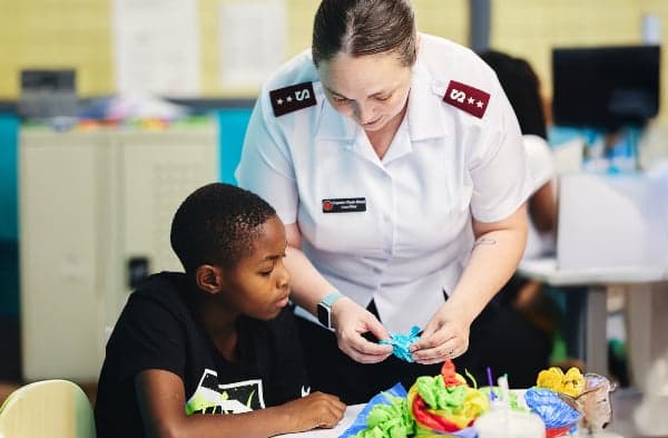 Salvation Army Officer talking and smiling with a community member.